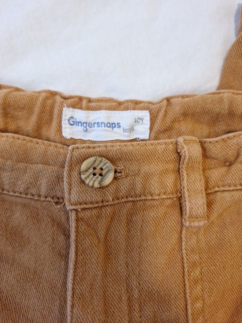 Gingersnaps Boys Pants (Category: Babies & Kids Fashion) located in Antipolo. Submitted by flutterby41319 (Listing ID 1429372712, Image 1). Description: These pants from Gingersnaps Boys feature a button closure and two front pockets. The pants have an elastic waistband and a straight leg design. The color is a warm brown. The brand tag is visible on the side. These pants are suitable for everyday wear. Size 10 .