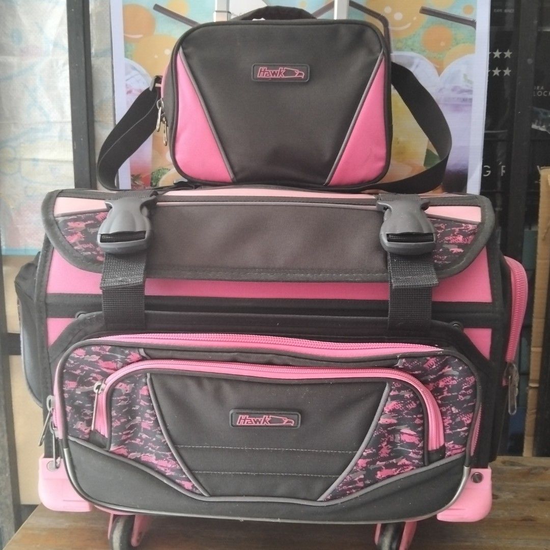 Hawk Rolling Backpack with Lunch Bag (Category: Strollers) located in Quezon City. Submitted by heybailey (Listing ID 1429386142, Image 1). Description: Hawk rolling backpack comes with a matching lunch bag. It features a pink and black color scheme with a camouflage pattern on some parts. The backpack has multiple compartments, including a side pocket for a water bottle. It has a handle and wheels for easy transport. The backpack also includes a