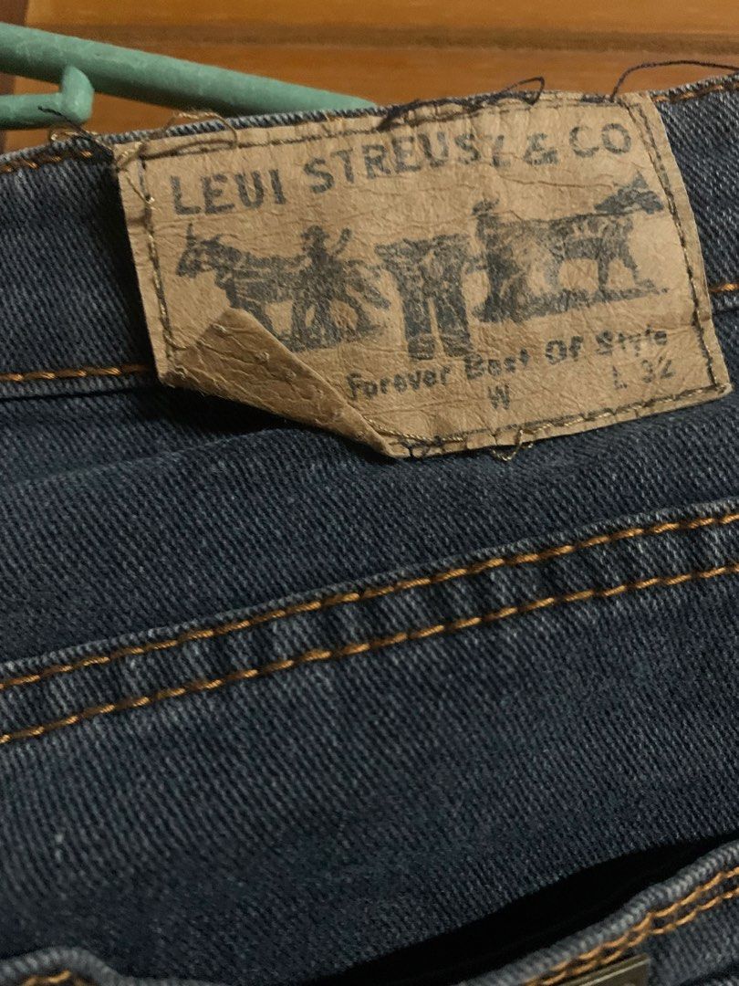 Levi Strauss & Co. Dark Wash Jeans (Category: Jeans) located in Manila. Submitted by foreverble80256 (Listing ID 1429412387, Image 3). Description: Dark wash jeans from Levi Strauss & Co. Features a classic five-pocket design. The back has two pockets with a red tab. The jeans have a straight leg cut. The size is W and L32..