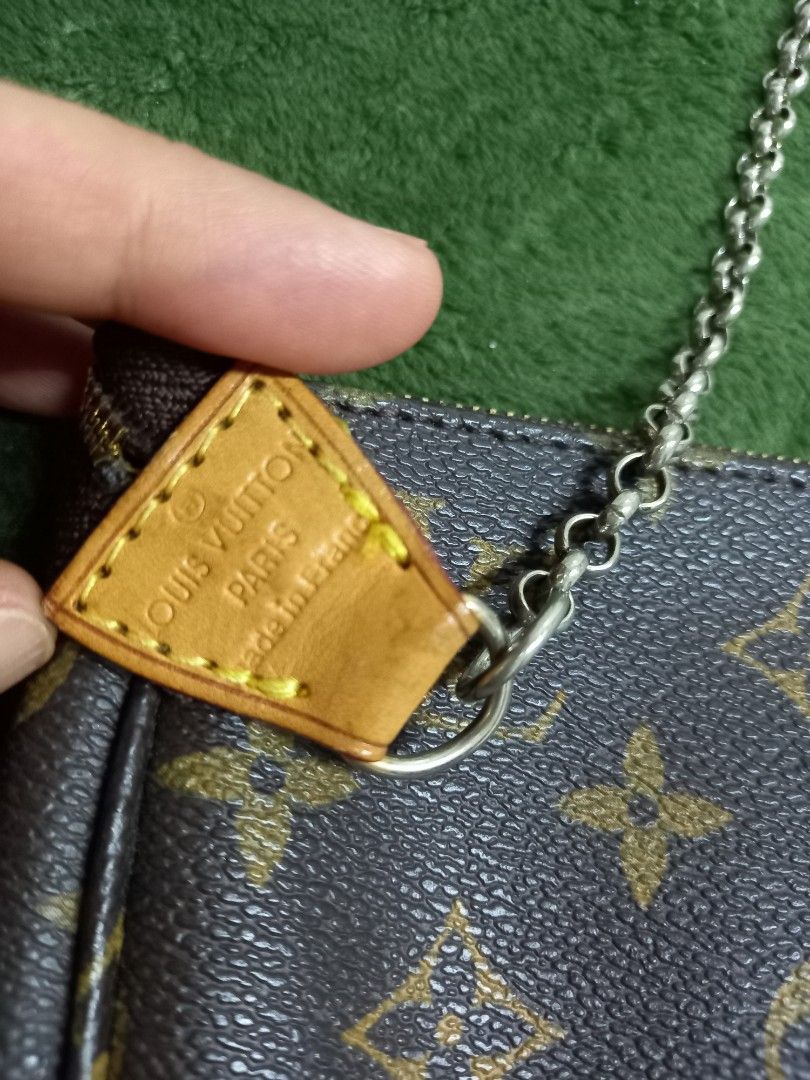 Louis Vuitton Pochette Accessoires Clutch (Category: Clutches) located in Tuguegarao City. Submitted by zenphoenix-7ad615 (Listing ID 1429441009, Image 3). Description: Louis Vuitton Pochette Accessoires clutch. Features the iconic Monogram canvas, a gold-tone zipper, and a chain strap. The interior is lined with brown fabric. Includes a leather tag with "Made in France" inscription. Perfect for carrying essentials. The zipper and chain hardware 