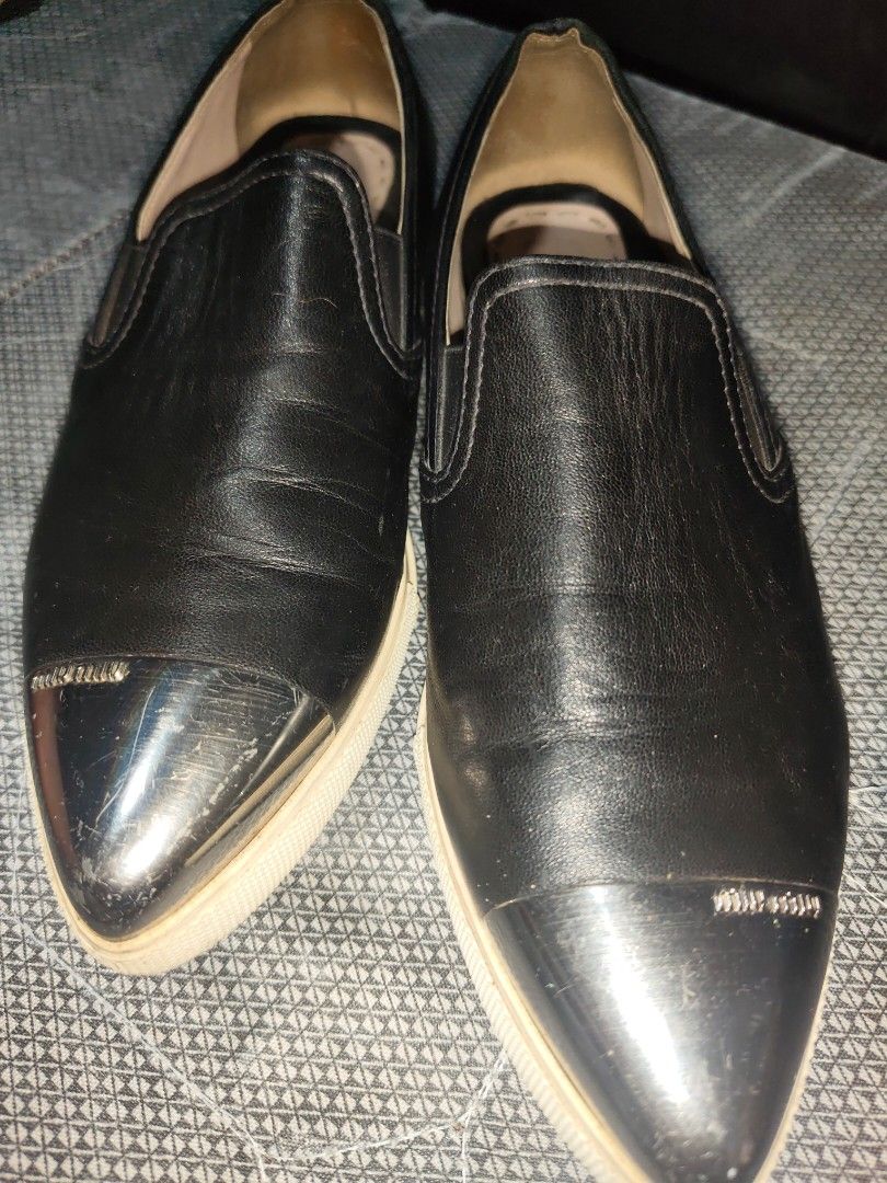 Miu Miu Black Leather Loafers (Category: Loafers) located in Manila. Submitted by endless_thrifts (Listing ID 1429392110, Image 2). Description: Black leather loafers from Miu Miu. Features a metal toe cap and the Miu Miu logo on the insole. The shoes have a slip-on design. The soles appear to be cream-colored..