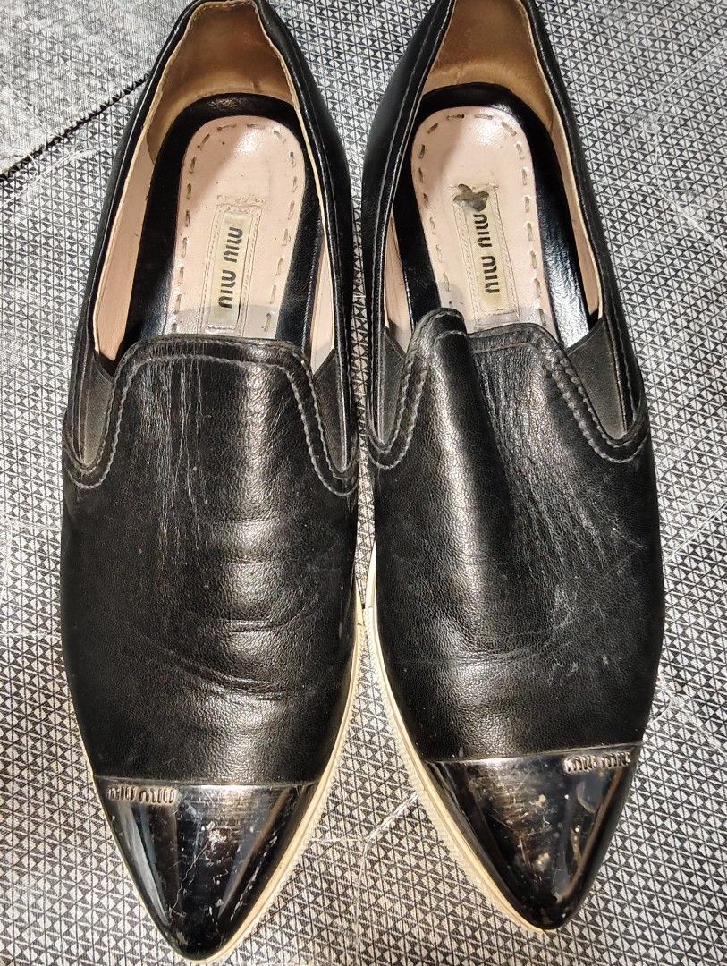 Miu Miu Black Leather Loafers (Category: Loafers) located in Manila. Submitted by endless_thrifts (Listing ID 1429392110, Image 1). Description: Black leather loafers from Miu Miu. Features a metal toe cap and the Miu Miu logo on the insole. The shoes have a slip-on design. The soles appear to be cream-colored..