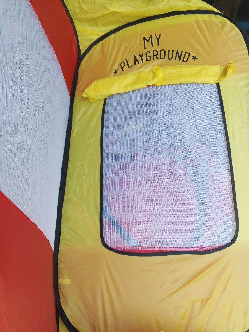 Modern House Play Pop-up Tent (Category: Infant Playtime) located in Davao. Submitted by jmhocson (Listing ID 1429383505, Image 2). Description: Modern House Play Pop-up Tent is perfect for indoor or outdoor fun. It features a vibrant yellow, red, and white design with the words "MY PLAYGROUND" on the front. The tent has mesh windows for ventilation and easy viewing. It's a great space for kids to play and imagine. The tent is foldable for easy s