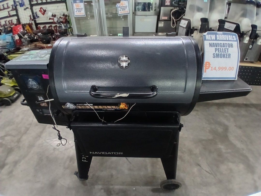 Navigator Pellet Smoker (Category: Cookware & Accessories) located in Manila. Submitted by sc_arvin (Listing ID 1429365221, Image 1). Description: Navigator pellet smoker is perfect for outdoor cooking. It features a black exterior, a side table, and a digital control panel. The smoker is on wheels for easy movement. The price tag shows ₱14,999.00..