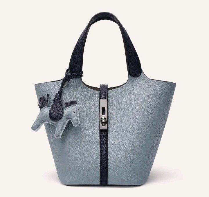 Navy Blue Handbag with Horse Charm (Category: Tote Bags) located in Makati City. Submitted by micmic804 (Listing ID 1429451378, Image 1). Description: - Navy blue handbag - Includes matching horse charm - Features a top handle - Secure closure - Simple and elegant design - Perfect for everyday use - Versatile navy blue color - Made of textured material.