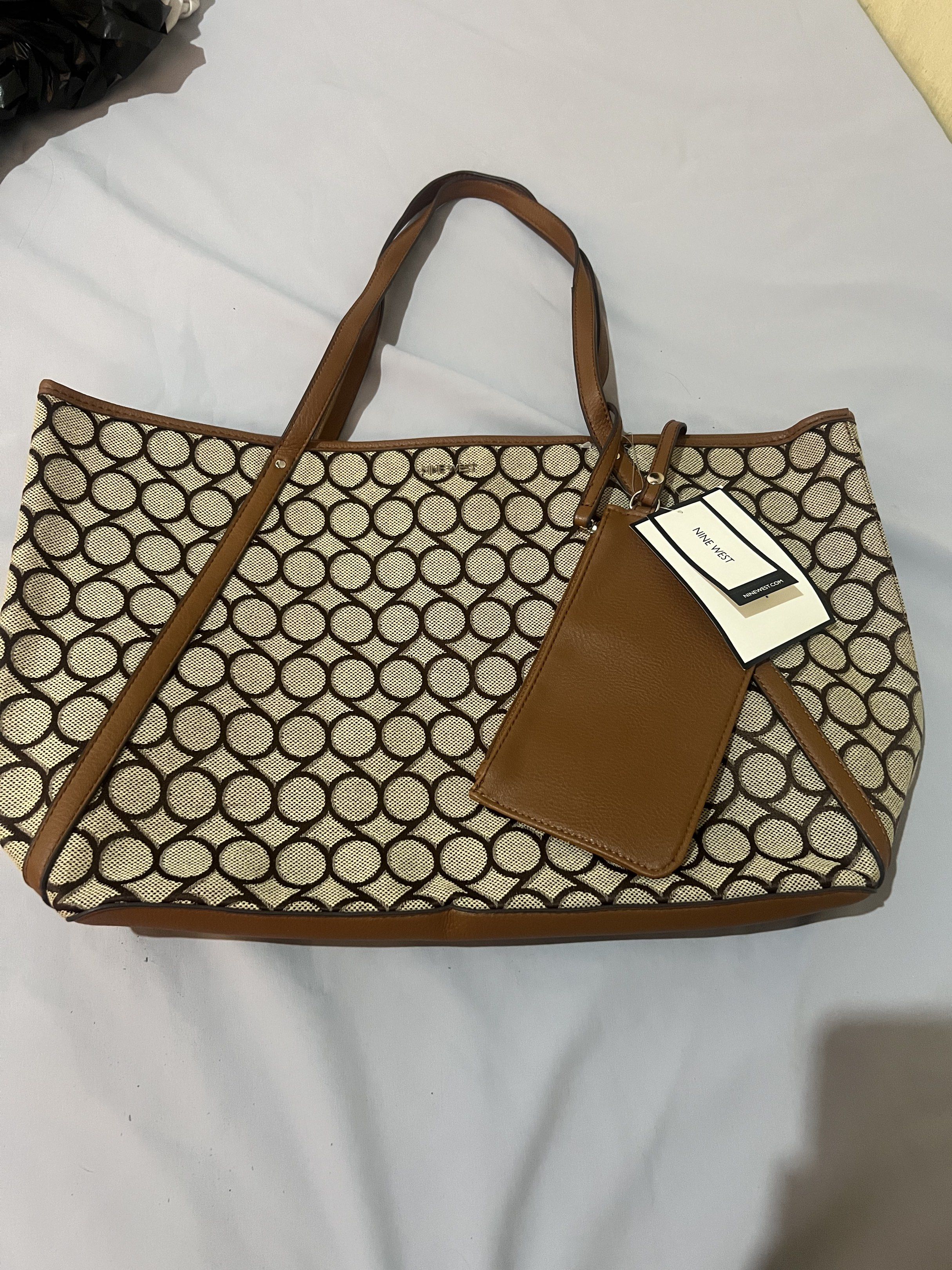 Nine West Vintage Tote Bag (Category: Tote Bags) located in Pasay City. Submitted by __mixfitz (Listing ID 1429370018, Image 1). Description: Bought here sa carousell for personal use sana, but realized it’s Too big for my body frame.. huhuhu never been used STYLE NUMBER: 60497856 - P34 COLOR: KHAKI TOBACCO BROWN Comes with detachable wristlet / pouch Dimensions 19” wide x 5.5” deep x 11” high .