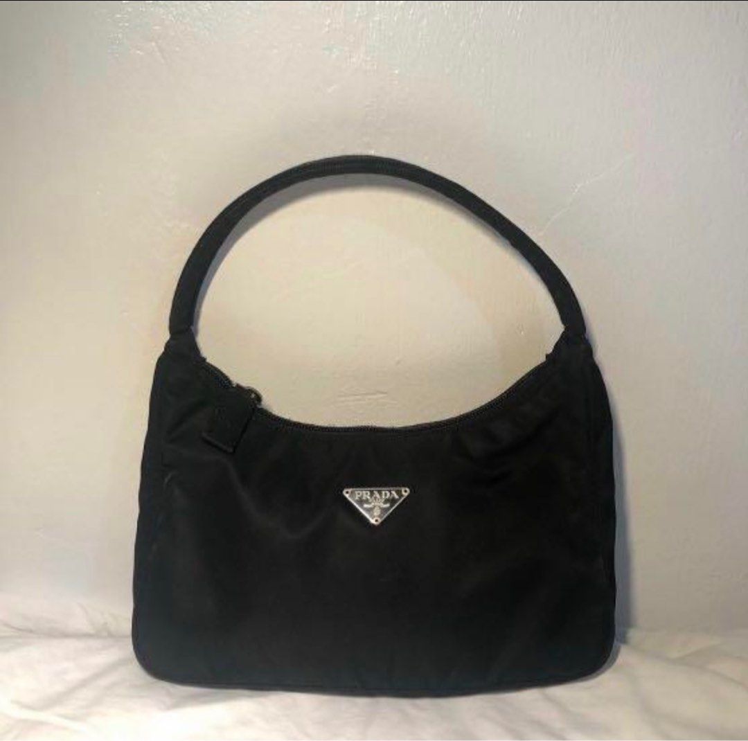 ORIGINAL Prada Black Nylon Mini Bag pochette Y2k (Category: Luxury Bags & Wallets) located in Mandaluyong City. Submitted by whitemoveout (Listing ID 1414583938, Image 2). Description: ORIGINAL VINTAGE RARE 25-35k pa to ibenta ng iba Prada mini bag in black nylon - Top handle - Zip closure - Small metal Prada logo - Interior pocket with "Made in Italy" tag UNLI LEGIT CHECK CAN MEET UP SO U CAN CHECK THOROUGHLY.