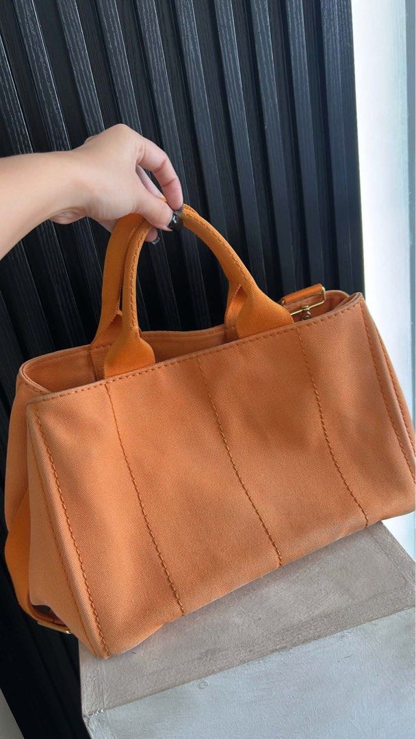 Prada Orange Canvas Tote Bag (Category: Luxury Bags & Wallets) located in Manila. Submitted by bagsdetails27 (Listing ID 1429380958, Image 3). Description: Prada Canapa Canvas Satchel Orange Pre owned Rank 9/10 Comes with dustbag, strap & cards 15,000.