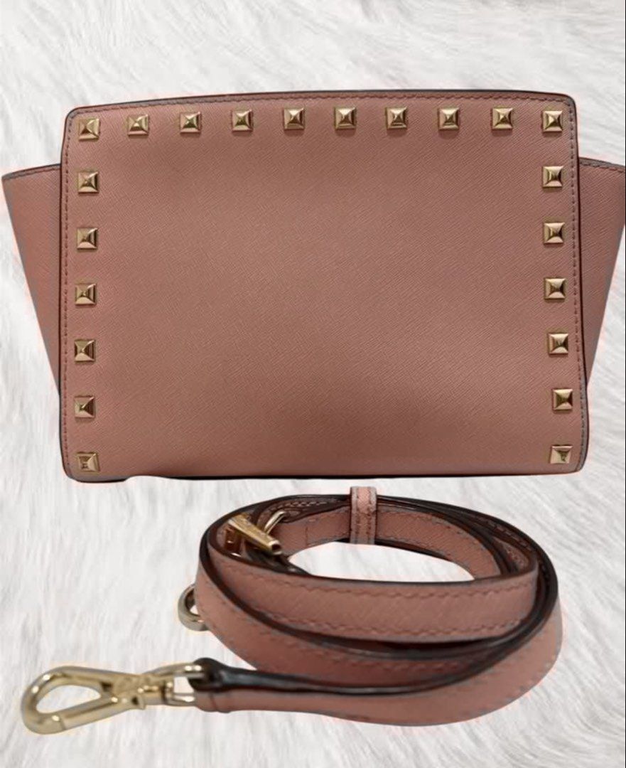 Preloved Michael Kors Studded Crossbody Bag (Category: Luxury Bags & Wallets) located in Manila. Submitted by JAngel (Listing ID 1429446983, Image 2). Description: Michael Kors crossbody bag features a blush pink color with gold-tone hardware. It has a studded design and comes with a detachable strap. The interior has a zip pocket and the Michael Kors logo lining..