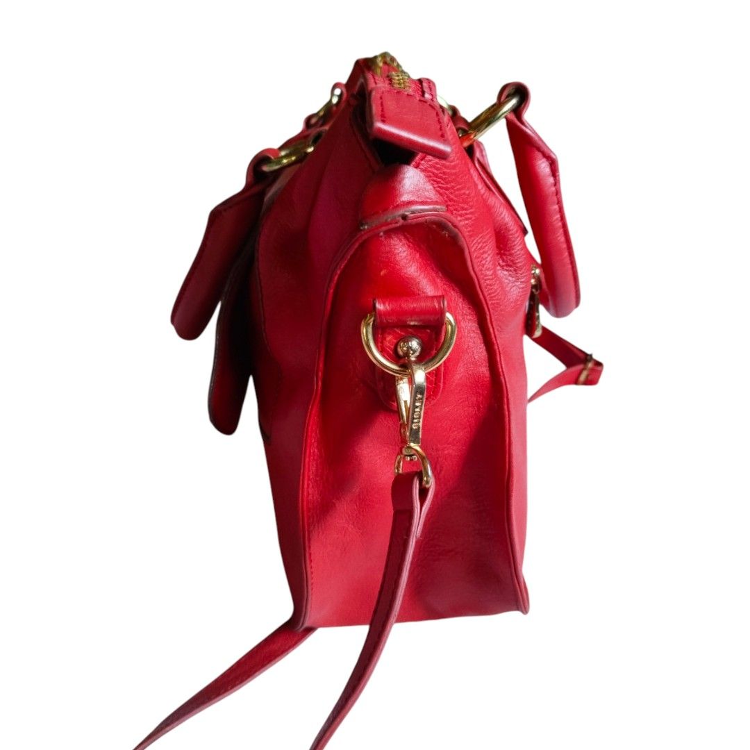 Sisley Red Leather Handbag (Category: Luxury Bags & Wallets) located in Bacolod City. Submitted by maejuntado33 (Listing ID 1429400923, Image 2). Description: Red leather handbag from Sisley features a top handle and a detachable shoulder strap. It has a flap closure with a buckle and gold-tone hardware. The bag has a zip closure and a logo detail on the front..