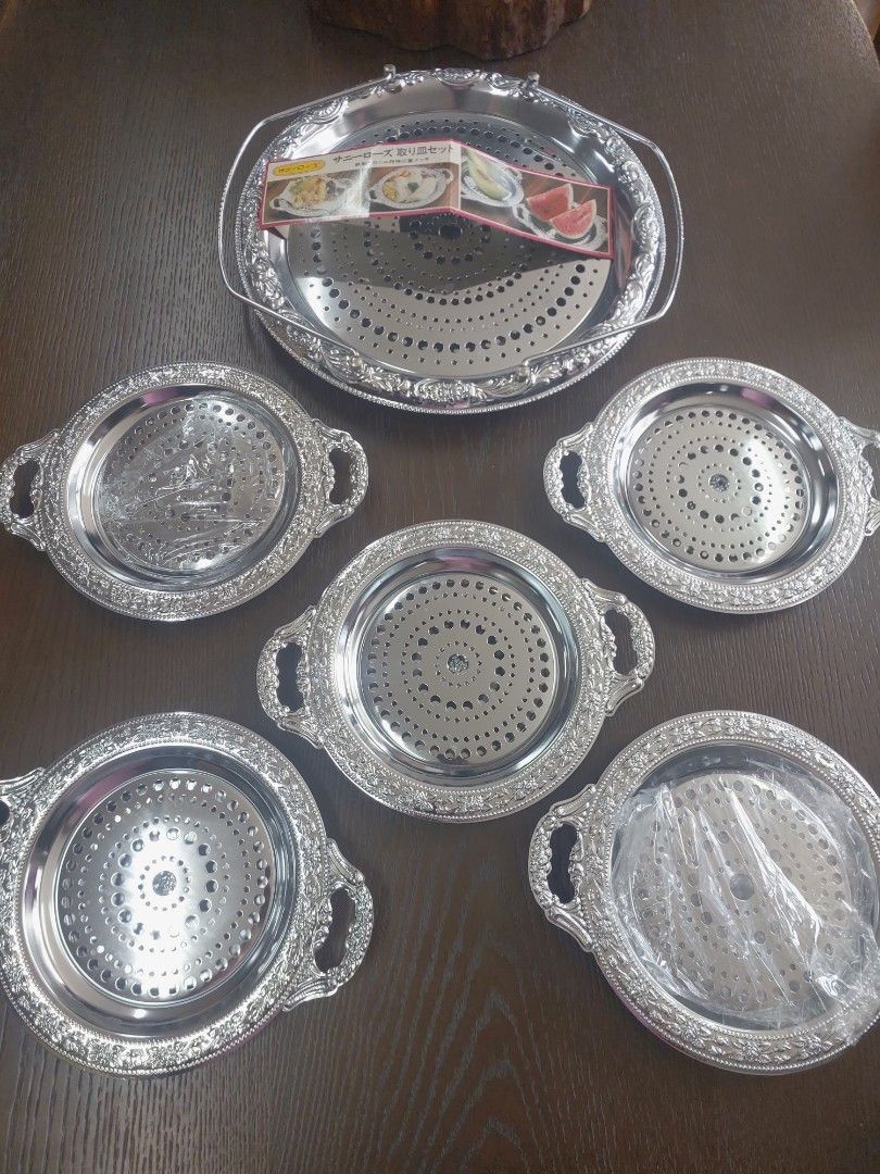 Sunny Rose Serving Tray Set (Category: Other Kitchenware & Tableware) located in Bulacan. Submitted by hnbfinds (Listing ID 1429375876, Image 3). Description: Sunny Rose stainless steel hors d'oeuvre dish set, which typically includes one large serving tray and five smaller individual plates. Product Details Brand/Series: Sunny Rose. Material: Stainless steel with a silver-colored finish. Components: The set in the image consists of a large handl