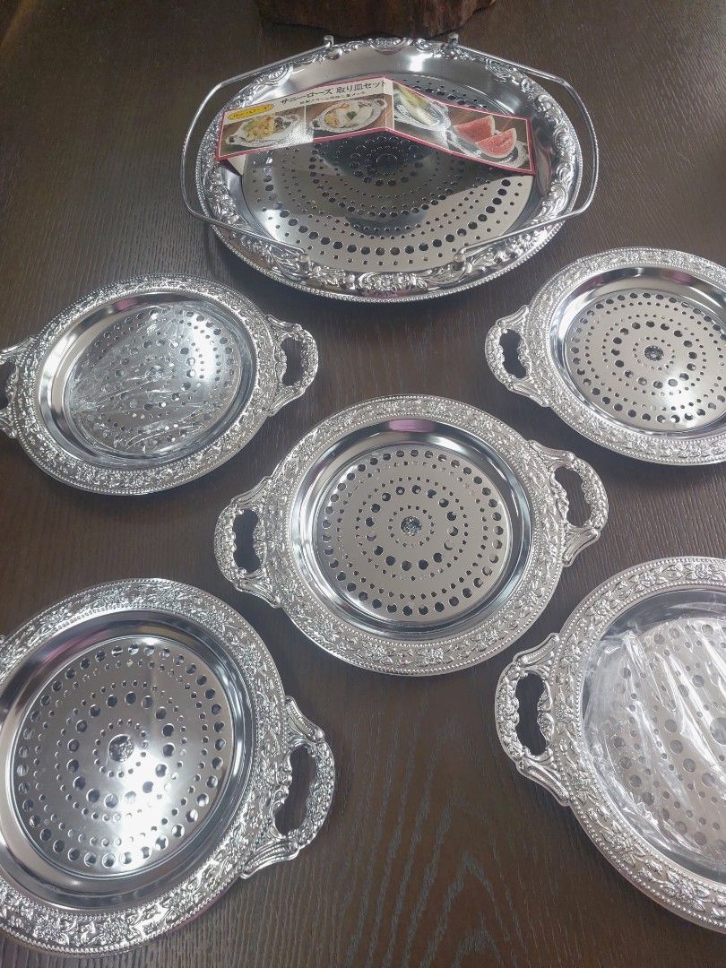 Sunny Rose Serving Tray Set (Category: Other Kitchenware & Tableware) located in Bulacan. Submitted by hnbfinds (Listing ID 1429375876, Image 2). Description: Sunny Rose stainless steel hors d'oeuvre dish set, which typically includes one large serving tray and five smaller individual plates. Product Details Brand/Series: Sunny Rose. Material: Stainless steel with a silver-colored finish. Components: The set in the image consists of a large handl