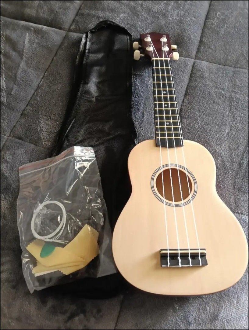 Ukulele with Accessories (Category: Musical Instruments) located in San Fernando. Submitted by elixiriaz (Listing ID 1429496964, Image 2). Description: - Ukulele with natural wood finish and dark red neck - Includes: freebies in the pic rfs: di nagagamit, super busy.