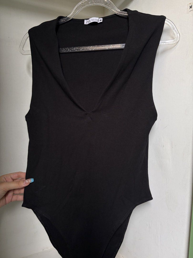 Zara Black Sleeveless Bodysuit (Category: Sleeveless) located in Pulilan. Submitted by margaretsedit (Listing ID 1429414928, Image 1). Description: Black sleeveless bodysuit from Zara. Features a V-neck design and snap closure at the bottom. Made of a soft, stretchy fabric. Size M. Perfect for layering or wearing on its own. A versatile piece for any wardrobe. Add 62 for SF.