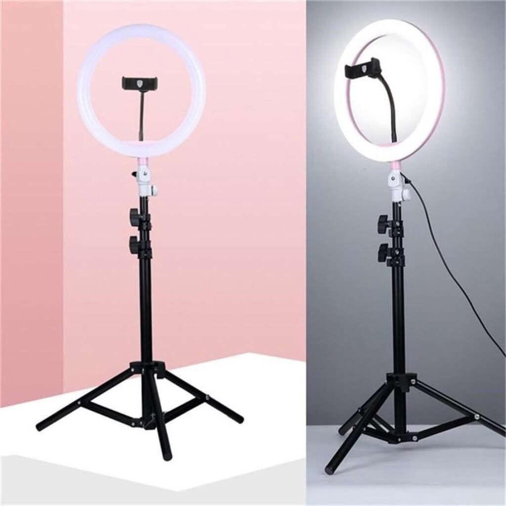 26cm LED Ring Light with Phone Holder (Category: Lighting & Studio Equipment) located in Manila. Submitted by yzlshop (Listing ID 1424564480, Image 1). Description: - Perfect for video recording, makeup, and photography. - Includes a phone holder for easy setup. - Adjustable height tripod stand. - Powered by a power cord. - Provides bright and even lighting..