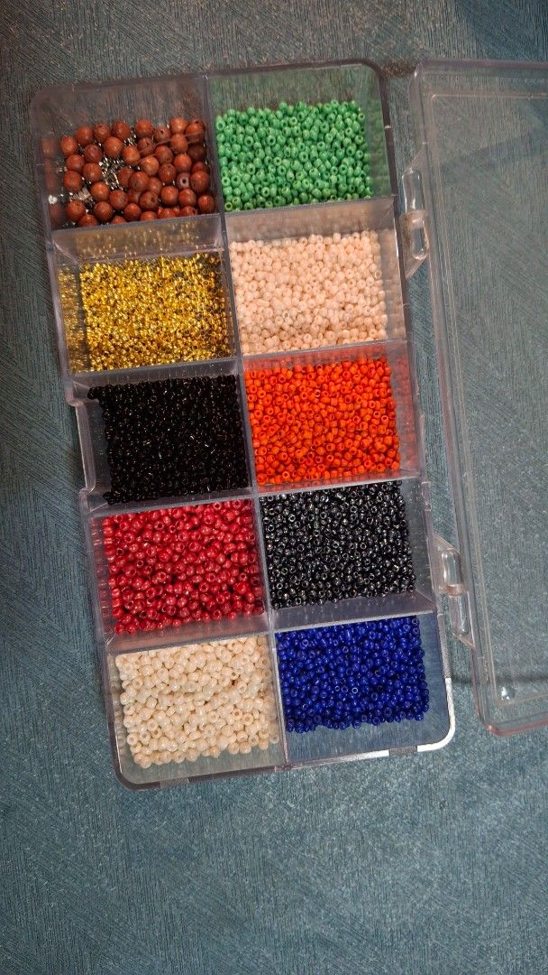 Assorted Seed Beads in Organizer (Category: Craft Supplies & Tools) located in Las Pinas. Submitted by mgr29 (Listing ID 1424643818, Image 2). Description: Collection of assorted seed beads in a clear plastic organizer. The beads come in a variety of colors, including green, beige, orange, black, blue, red, and gold. The organizer has multiple compartments to keep the beads separated. Perfect for jewelry making or other craft projects..