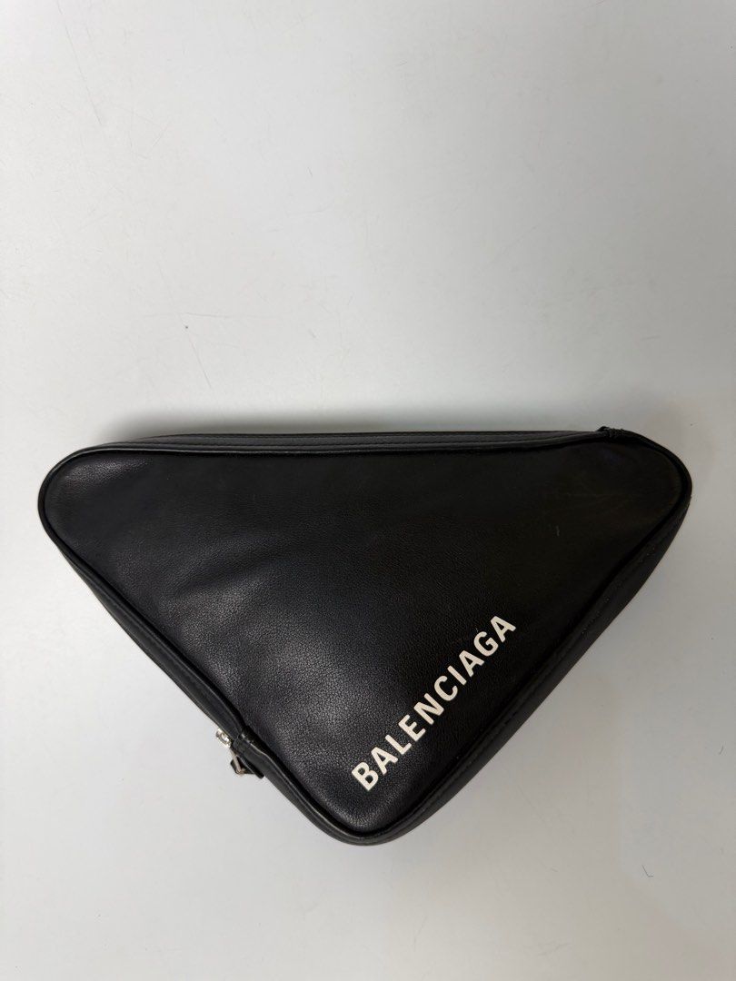 Balenciaga Triangle Clutch (Category: Luxury Bags & Wallets) located in Bayambang. Submitted by aevan143 (Listing ID 1424592808, Image 2). Description: - Balenciaga Triangle Clutch - Black exterior with white Balenciaga logo - Red interior - Interior features Balenciaga logo and serial number - Zip closure - Made in Italy.