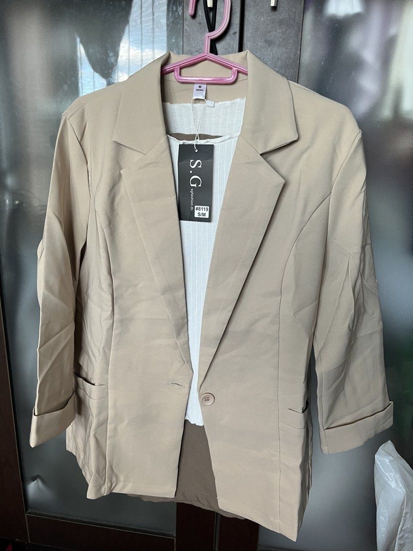 Beige color Blazer Medium Thailand (Category: Coats, Jackets and Outerwear) located in Mandaluyong City. Submitted by stephmd (Listing ID 1424579339, Image 2). Description: - Beige blazer from S.G. Made in Thailand - Size: M - Features a single-button closure. - Has three-quarter sleeves. - Includes two front pockets. - shipping only via J&T.