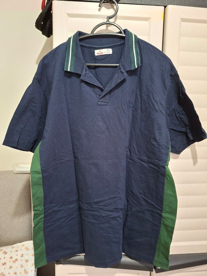 Bench Polo Shirt XXL (Category: Tshirts & Polo Shirts ) located in Manila. Submitted by shelly2004 (Listing ID 1424608793, Image 1). Description: - Navy blue Bench polo shirt - Size: XXL - Green stripe details on collar and sides - Collared neckline with a three-button placket - Short sleeves - Relaxed fit - Bench logo visible.