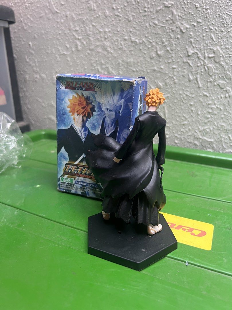 Bleach Ichigo Kurosaki Figure (Category: Figurines & Statues) located in Zamboanga. Submitted by lcomprendio26013 (Listing ID 1424591748, Image 3). Description: - Class A figure only Ichigo Kurosaki figure from Bleach. - Includes original box. - Figure is posed with his sword and cape. - Box features Japanese text and character art. - Figure is displayed on a black hexagonal base. 149 only.