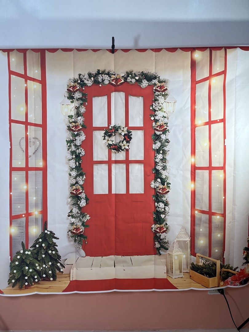 Christmas Door Backdrop (Category: Wall Decor) located in Caloocan City. Submitted by spaceshiip (Listing ID 1424545121, Image 1). Description: - Festive Christmas backdrop - Features a red door design with wreath and garland - Includes window frames with Christmas lights - Features small Christmas trees - Ideal for holiday photoshoots and decorations - Easy to set up.