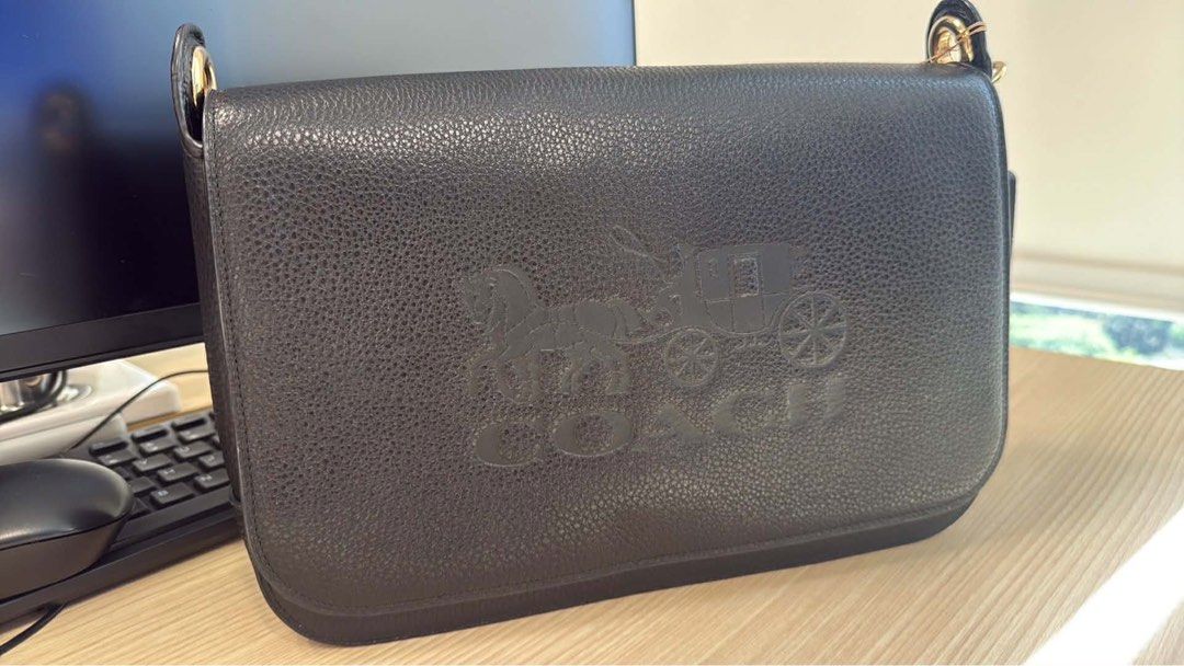 Coach Black Leather Shoulder Bag (Category: Luxury Bags & Wallets) located in Pasay City. Submitted by shengrodanilla (Listing ID 1424625700, Image 2). Description: - Authentic Coach shoulder bag - Flap closure - Embossed Coach logo - Detachable and adjustable shoulder strap - Gold-tone hardware with silver stripe - Made of leather.
