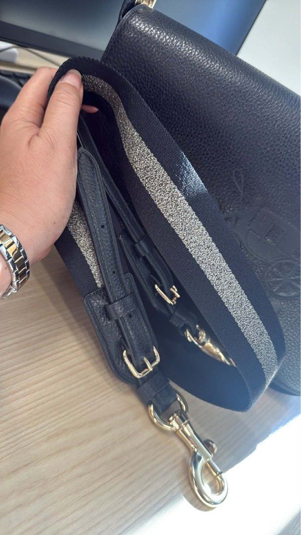Coach Black Leather Shoulder Bag (Category: Luxury Bags & Wallets) located in Pasay City. Submitted by shengrodanilla (Listing ID 1424625700, Image 3). Description: - Authentic Coach shoulder bag - Flap closure - Embossed Coach logo - Detachable and adjustable shoulder strap - Gold-tone hardware with silver stripe - Made of leather.