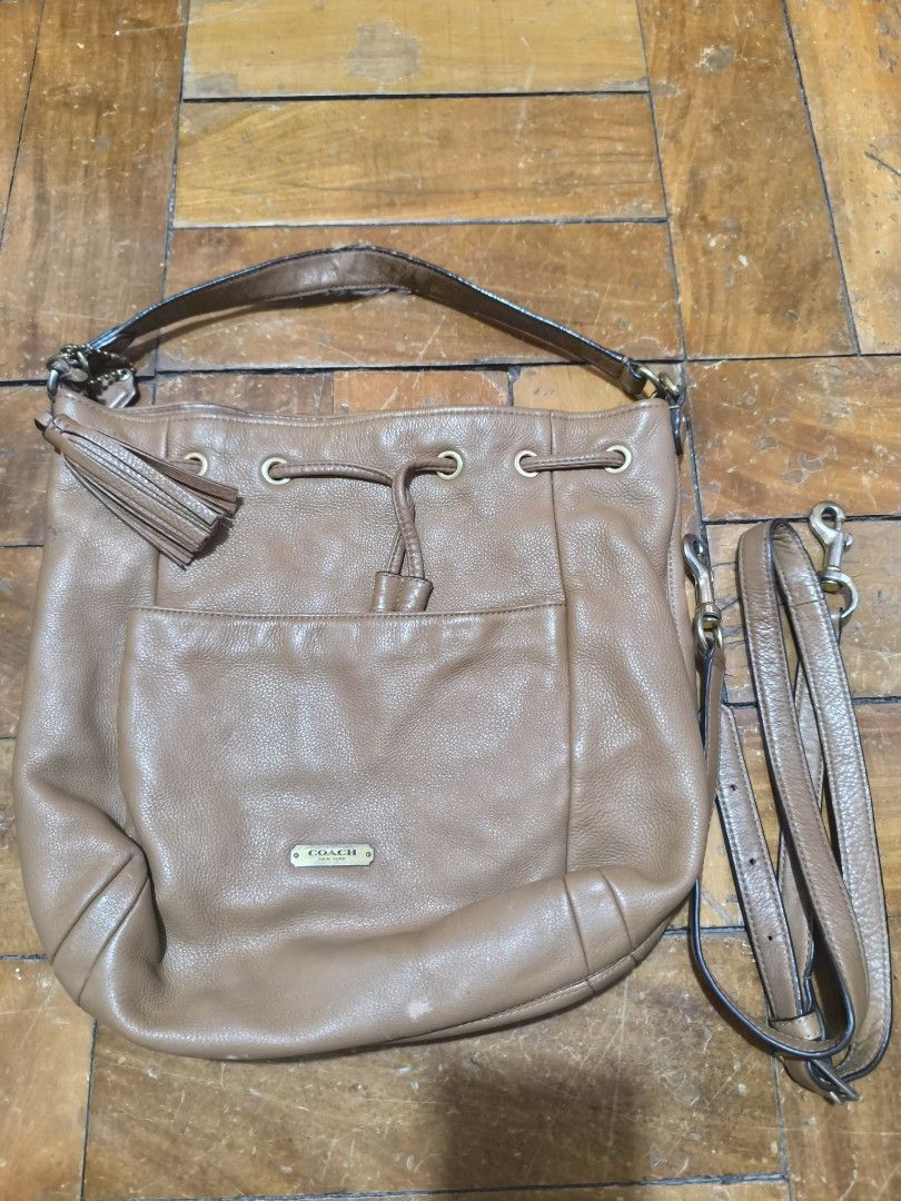 Coach Drawstring Shoulder Bag (Category: Luxury Bags & Wallets) located in Baguio. Submitted by tifay27 (Listing ID 1424542184, Image 1). Description: - Coach handbag - Drawstring closure - Light brown color - Gold-tone hardware - Detachable shoulder strap - Front pocket - Tassel detail - Main compartment and additional pockets.