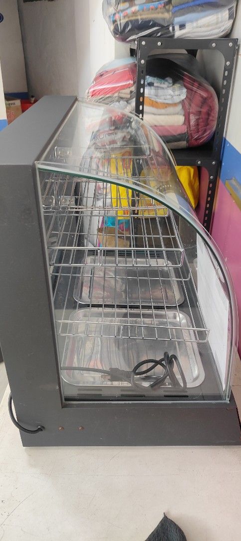 Commercial Food Warmer Display (Category: Food Organization & Storage) located in San Juan City. Submitted by master_aga.criket (Listing ID 1424570648, Image 2). Description: - Commercial food warmer - Multiple shelves and trays - Glass display case with black frame - Temperature control knob - Keeps food warm and ready to serve - Includes power cord - Ideal for restaurants and cafes.