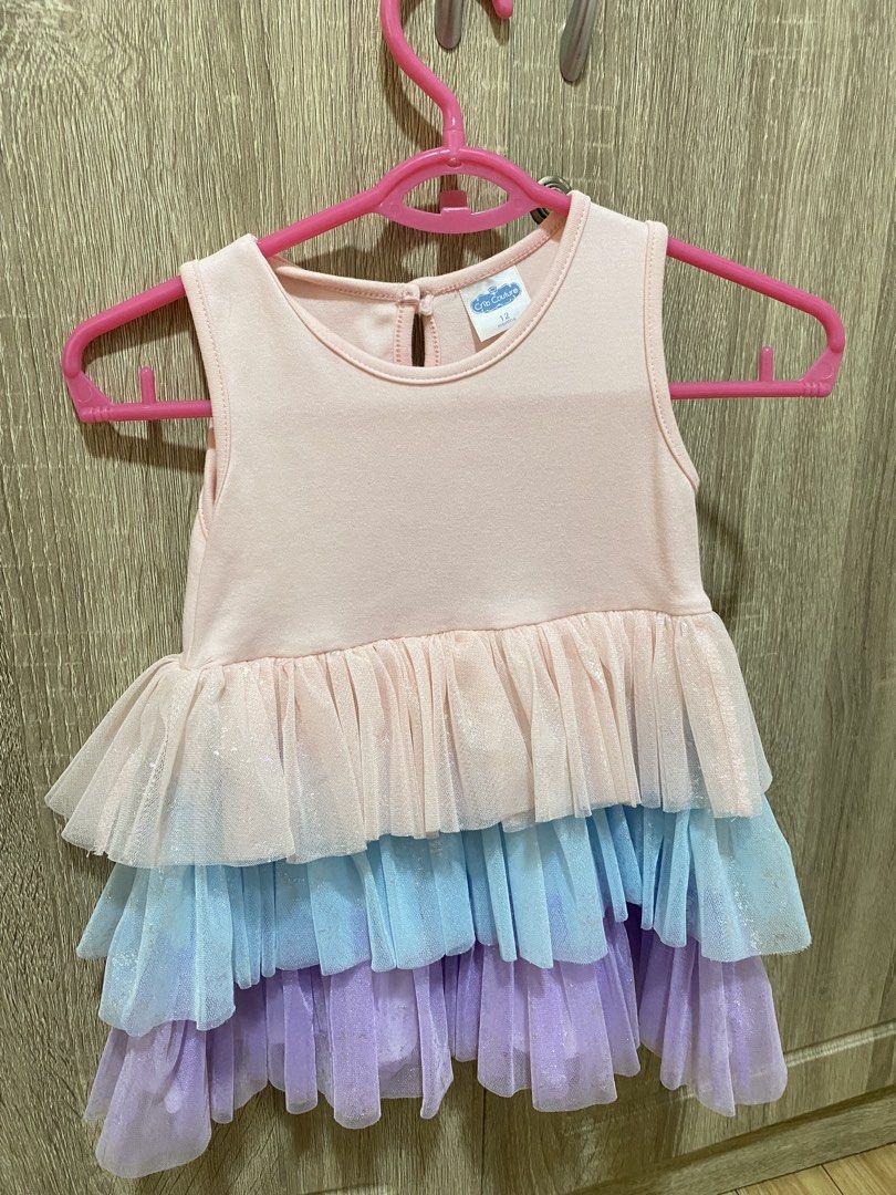 Crib Couture Ruffle Dress - 12 Months (Category: Babies & Kids Fashion) located in San Pedro. Submitted by cris1923 (Listing ID 1424633907, Image 1). Description: - Crib Couture dress for 12-month-old baby. - Sleeveless design. - Round neckline. - Light pink bodice. - Multi-colored ruffle skirt (pink, blue, purple)..