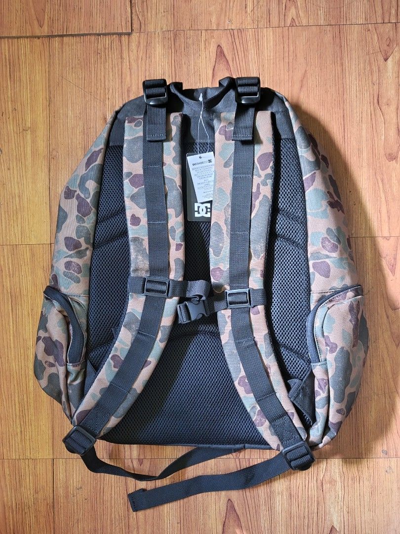 DC Camo Backpack (Category: Backpacks) located in Calabanga. Submitted by just-thrift (Listing ID 1424627362, Image 2). Description: - Brand new DC camouflage backpack with hang tag - Main compartment for storage - Front zippered pocket - Side pockets for extra storage - Adjustable shoulder straps for comfort - Top handle for easy carrying - Features the iconic DC logo - Comes with original tags and packaging.