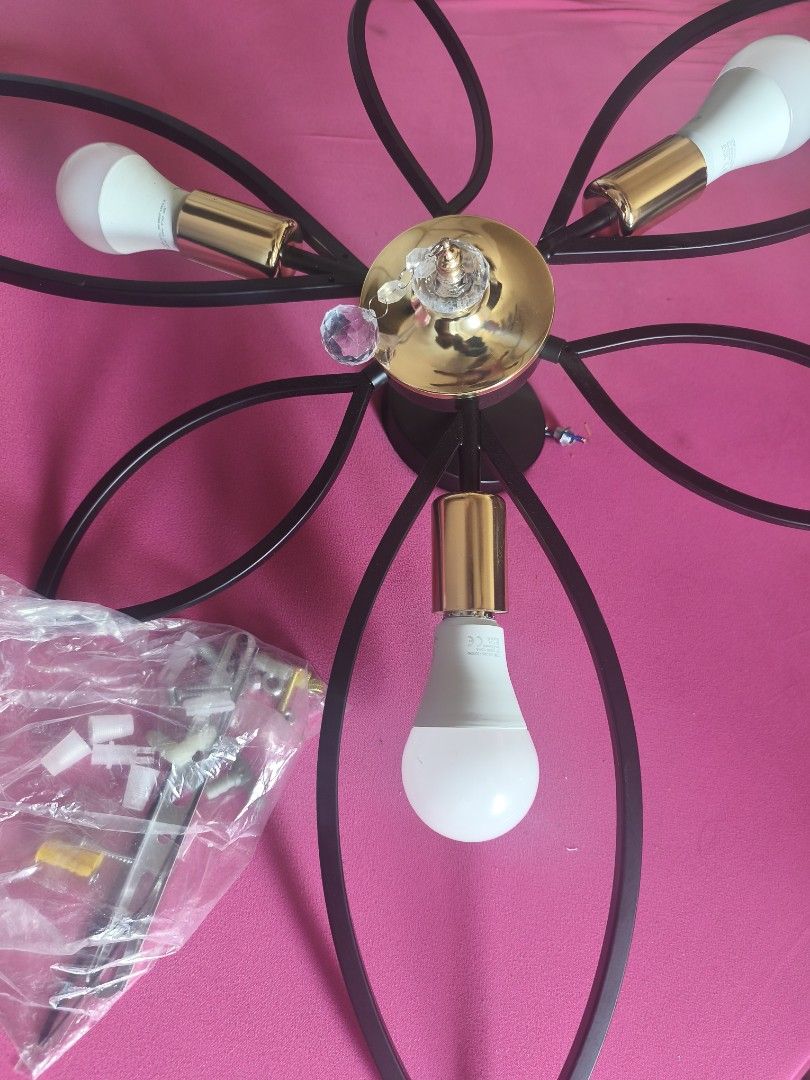 Floral Design Ceiling Light (Category: Lighting) located in Cavite. Submitted by Combiishop (Listing ID 1424543236, Image 1). Description: - Elegant floral design ceiling light - Black metal frame with gold accents - - Central gold-colored base with crystal element - Comes with mounting hardware this ceiling decor light is new plan namin ikabit sa room ang problema natbago isip wala na ako mapagagamitan nito baka may gusto pwede kayo ang magbook 