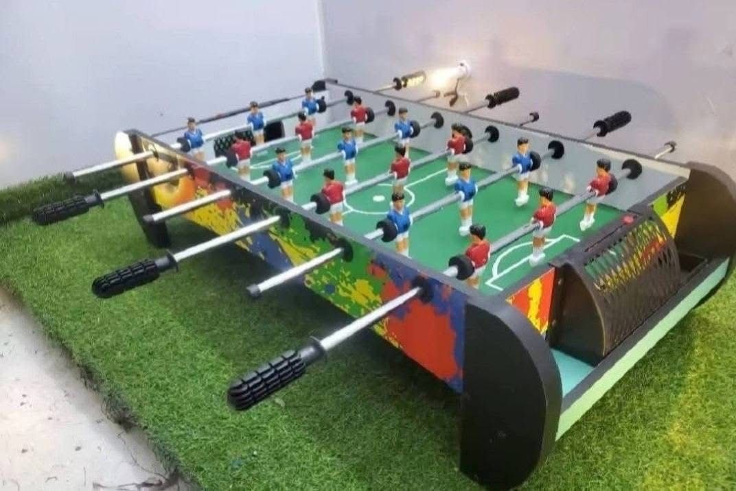 Foosball Table - Colorful Design (Category: Board Games & Puzzles) located in San Pablo. Submitted by vennisa.sportssupplies (Listing ID 1424596080, Image 2). Description: - Vibrant foosball table with a colorful design. - Features red and blue player uniforms. - Includes a green playing surface. - Equipped with a convenient ball return system. - Comes with black handles. - Sturdy base for stability. - Perfect for fun with friends and family..