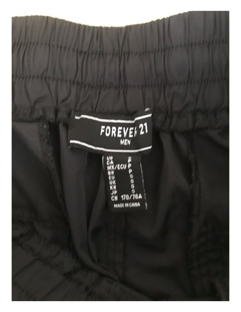 Forever 21 Men Track Pants (Category: Joggers) located in Makati City. Submitted by things77 (Listing ID 1424563665, Image 3). Description: - Black track pants - Neon green side stripes - Elastic waistband - Single back pocket - Brand: Forever 21 Men W: 30 inches H: 37 inches.