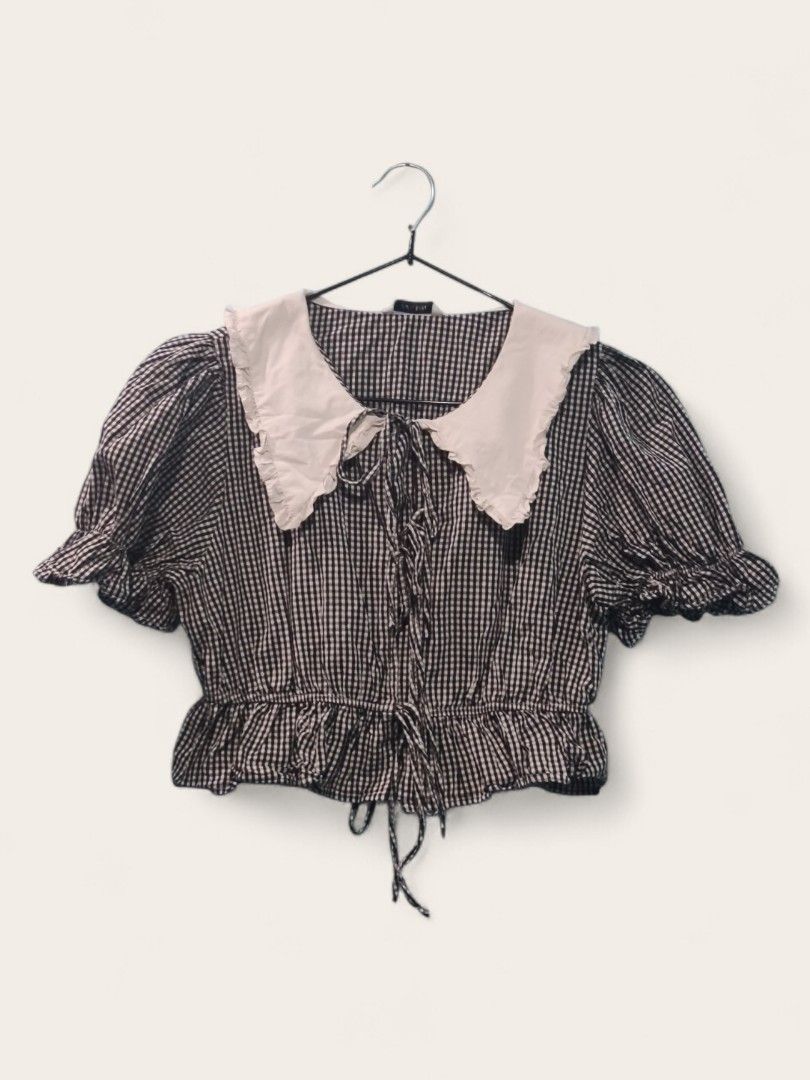 Gingham Checkered Blouse with Peter Pan Collar (Category: Blouses) located in Quezon City. Submitted by thiftthiftlang (Listing ID 1424656937, Image 1). Description: Gingham Checkered Blouse with Peter Pan Collar Front tie, puffy sleeves. Medida Size: Bust: 34 inch Length: 14 inch MOP: Gcash MOD: JnT/Lalamove Sf is shouldered by buyer.