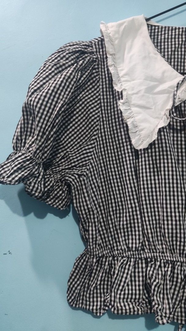 Gingham Checkered Blouse with Peter Pan Collar (Category: Blouses) located in Quezon City. Submitted by thiftthiftlang (Listing ID 1424656937, Image 2). Description: Gingham Checkered Blouse with Peter Pan Collar Front tie, puffy sleeves. Medida Size: Bust: 34 inch Length: 14 inch MOP: Gcash MOD: JnT/Lalamove Sf is shouldered by buyer.