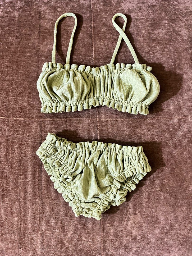 Green Ruffled Bikini Set (Category: Bikinis & Swimsuits) located in Quezon City. Submitted by copthis___ (Listing ID 1424635036, Image 1). Description: - Sage green bikini set - Features a ruffled stretchable design - Fabric: Textured, crinkled appearance - Ideal for beach days and pool parties.