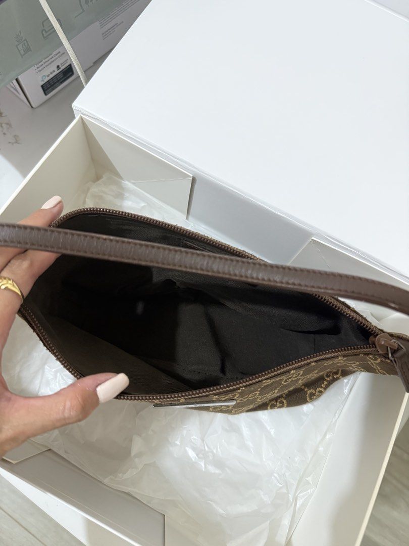 Gucci Pochette Monogram Canvas Bag (Category: Luxury Bags & Wallets) located in Valenzuela. Submitted by solanaph (Listing ID 1424635673, Image 3). Description: - Authentic Gucci bag - Features the iconic GG monogram - Brown canvas exterior - Matching leather strap - Rectangular shape - Secure zipper closure - Dark brown fabric interior lining - Rare color 🤎 brought from Ancia (ig) - used only once from an event.