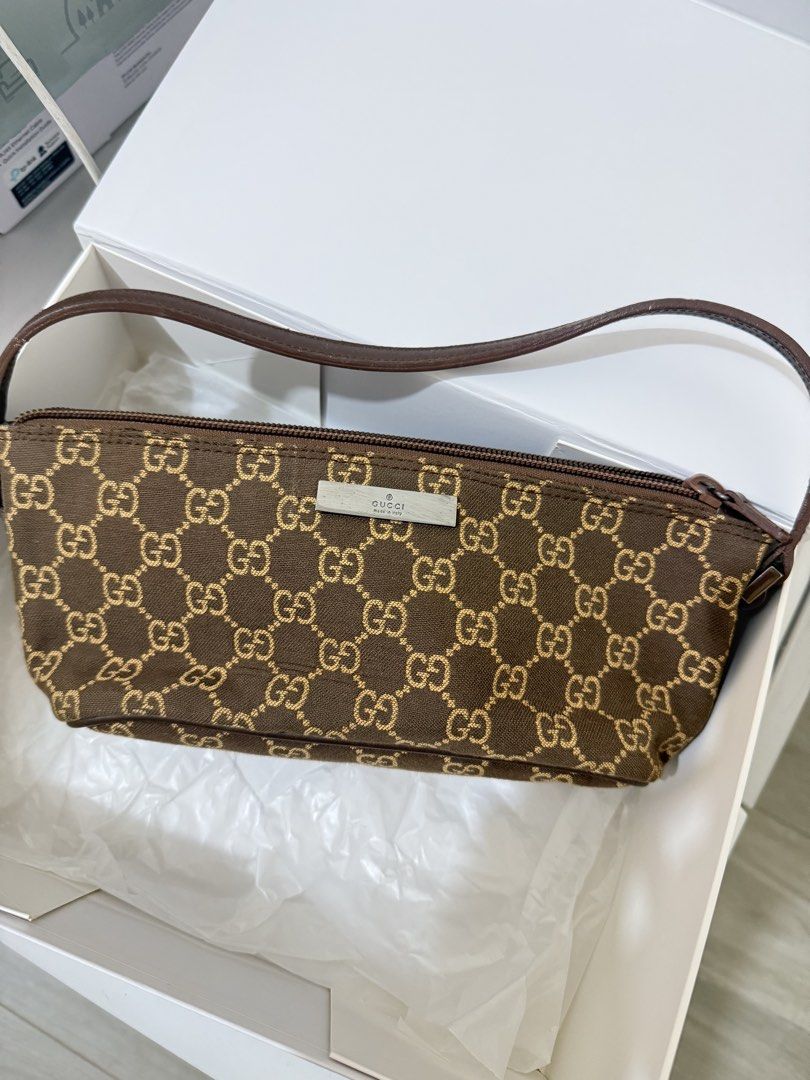 Gucci Pochette Monogram Canvas Bag (Category: Luxury Bags & Wallets) located in Valenzuela. Submitted by solanaph (Listing ID 1424635673, Image 2). Description: - Authentic Gucci bag - Features the iconic GG monogram - Brown canvas exterior - Matching leather strap - Rectangular shape - Secure zipper closure - Dark brown fabric interior lining - Rare color 🤎 brought from Ancia (ig) - used only once from an event.