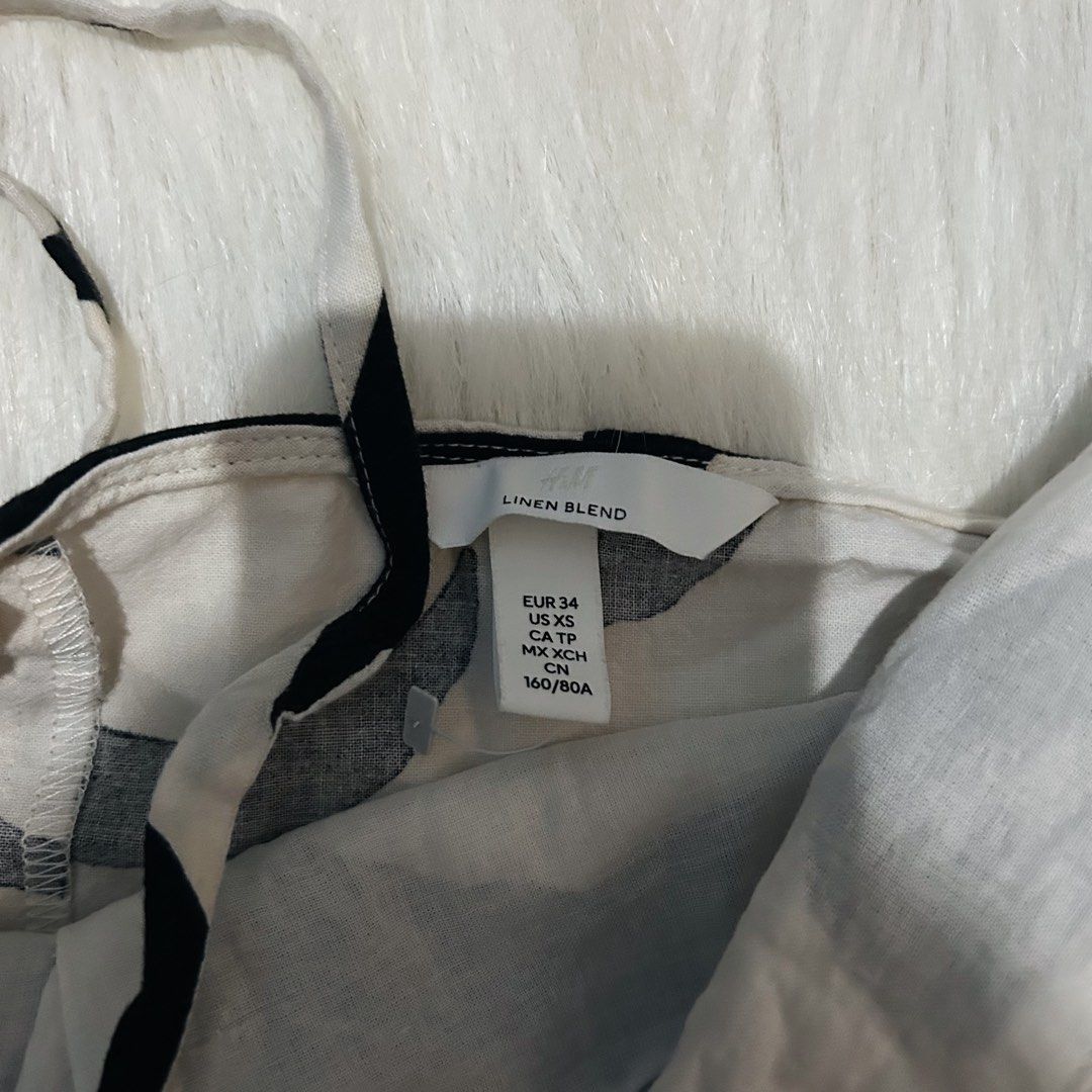 H&M Linen Blend Dress (Category: Dresses) located in Cebu City. Submitted by brandsandtags2 (Listing ID 1424625842, Image 3). Description: - H&M dress - Size: XS - Print: Black and white abstract - Fabric: Linen blend - Features: Adjustable straps - Style: Fitted silhouette.