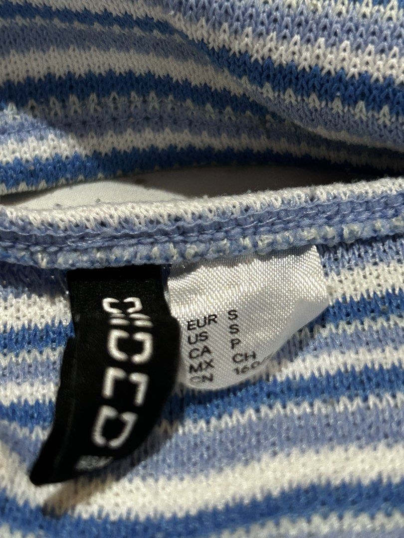H&M Striped Blue & White Halter Top - Size S (Category: Sleeveless) located in Caloocan City. Submitted by ctrl12 (Listing ID 1424564225, Image 3). Description: - In blue and white stripes. - Classic halter neck design - Fitted bodice - Knit fabric - Stylish for summer, warm weather or layering Features a halter neck design and a ribbed texture. The tag indicates a size S. MOP: GCash MOD: Lalamove / J&T Helping tags: urban outfitters zara uniqlo 