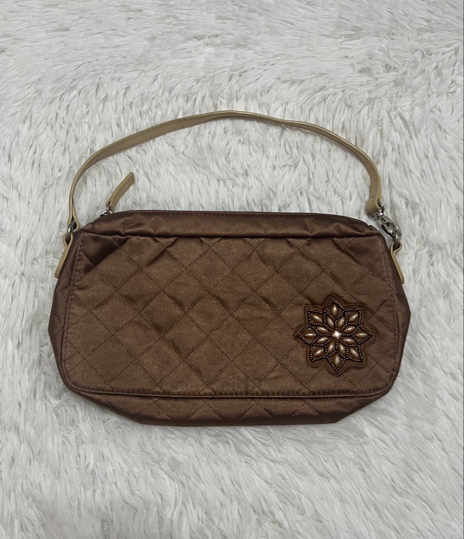 Jacob Brown Quilted Baguette Bag (Category: Luxury Bags & Wallets) located in Silang. Submitted by _superjea (Listing ID 1424624789, Image 1). Description: - Brown quilted bag - Decorative flower embellishment - Beige handle - Silver zipper - Pink interior lining - Shoulder bag or small handbag - Satin-like texture.