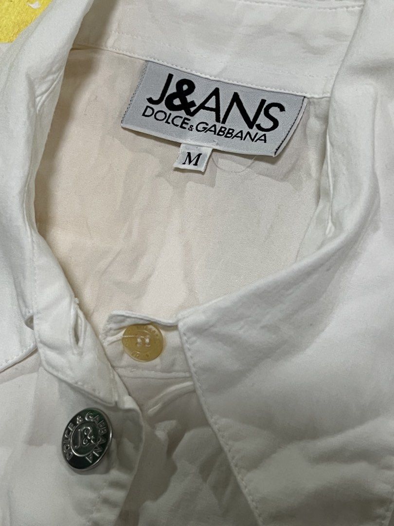 J&ANS Dolce & Gabbana Sleeveless Top (Category: Luxury Apparel) located in Calapan. Submitted by axlefinestpicks (Listing ID 1424687682, Image 2). Description: - J&ANS Dolce & Gabbana sleeveless top - White color - Size M - Made in Italy - 100% cotton - Button-down front - Features logo buttons.