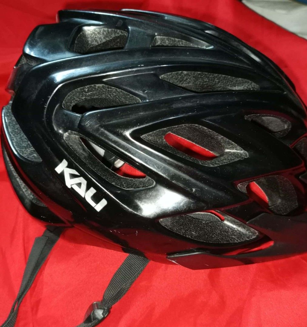 Kali Black Cycling Helmet (Category: Bicycles) located in Kawit. Submitted by monshop714 (Listing ID 1424527001, Image 2). Description: Black cycling helmet, Features the Kali logo on the side. Includes adjustable straps and interior padding for comfort and safety. The helmet has a butterfly logo on the back. The interior has a red lining. USA made.