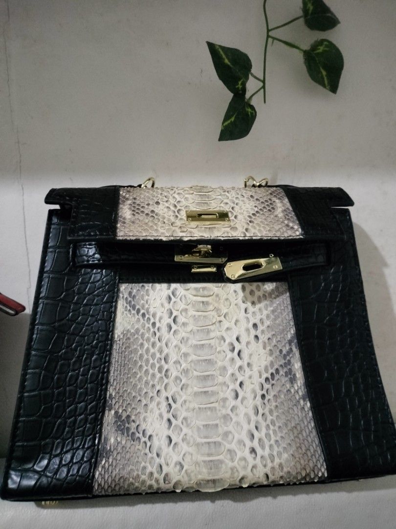 Kelly Snakeskin Sling bag (Category: Luxury Bags & Wallets) located in General Trias. Submitted by sensei_annyana (Listing ID 1424645260, Image 2). Description: - Black and white snakeskin handbag - Structured design - With Sling - Secure lock closure - Crocodile-like texture on black sections.