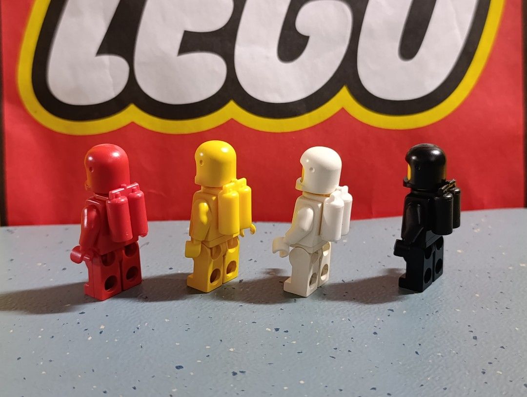 Lego Classic Space Minifigures (Category: Lego & Building Sets) located in Quezon City. Submitted by vincentgo2024 (Listing ID 1424687476, Image 2). Description: Set of four Lego Classic Space minifigures. Includes red, yellow, white, and black spacemen. Each figure has a classic space logo on the torso and a yellow head. The figures are complete with their air tanks. A great addition to any Lego collection..