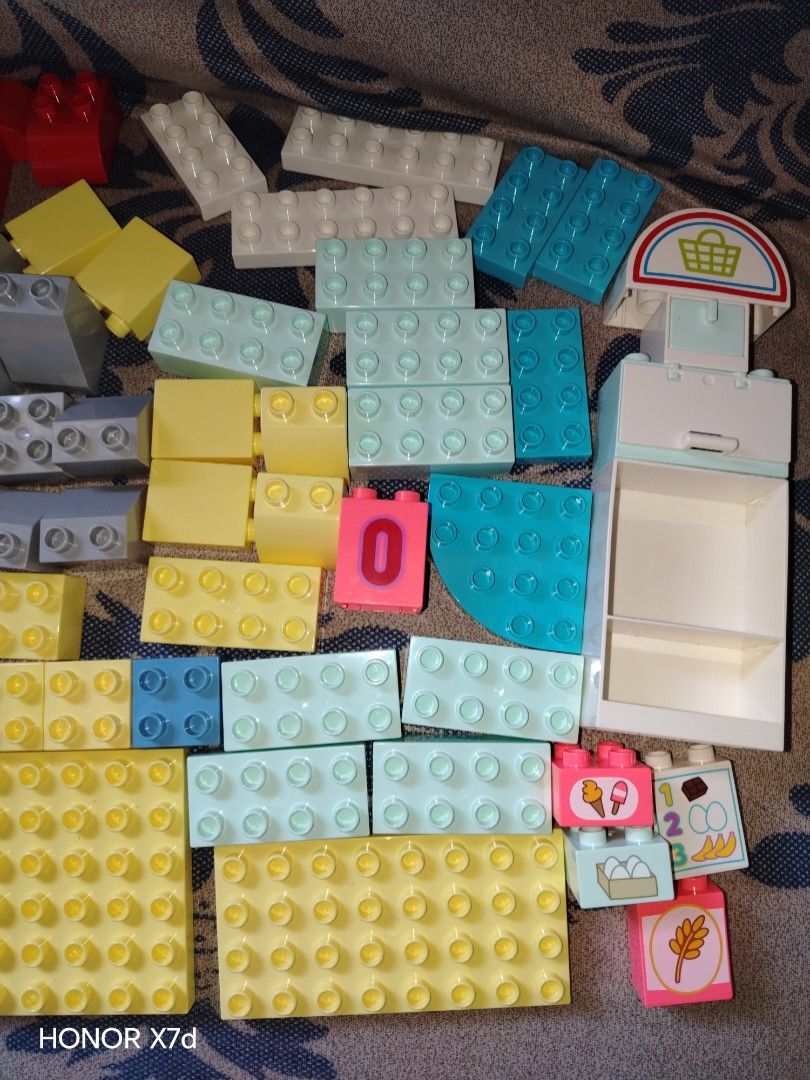 Lego Duplo mix Vintage 128pcs (Category: Lego & Building Sets) located in San Luis. Submitted by cknfaithtoysshop1831 (Listing ID 1424416530, Image 2). Description: Colorful set of Duplo building blocks. Includes various sizes and shapes, such as large rectangular blocks, smaller square blocks, and special pieces with printed designs. Features a variety of colors including yellow, red, blue, green, and white. Some blocks have numbers and other de