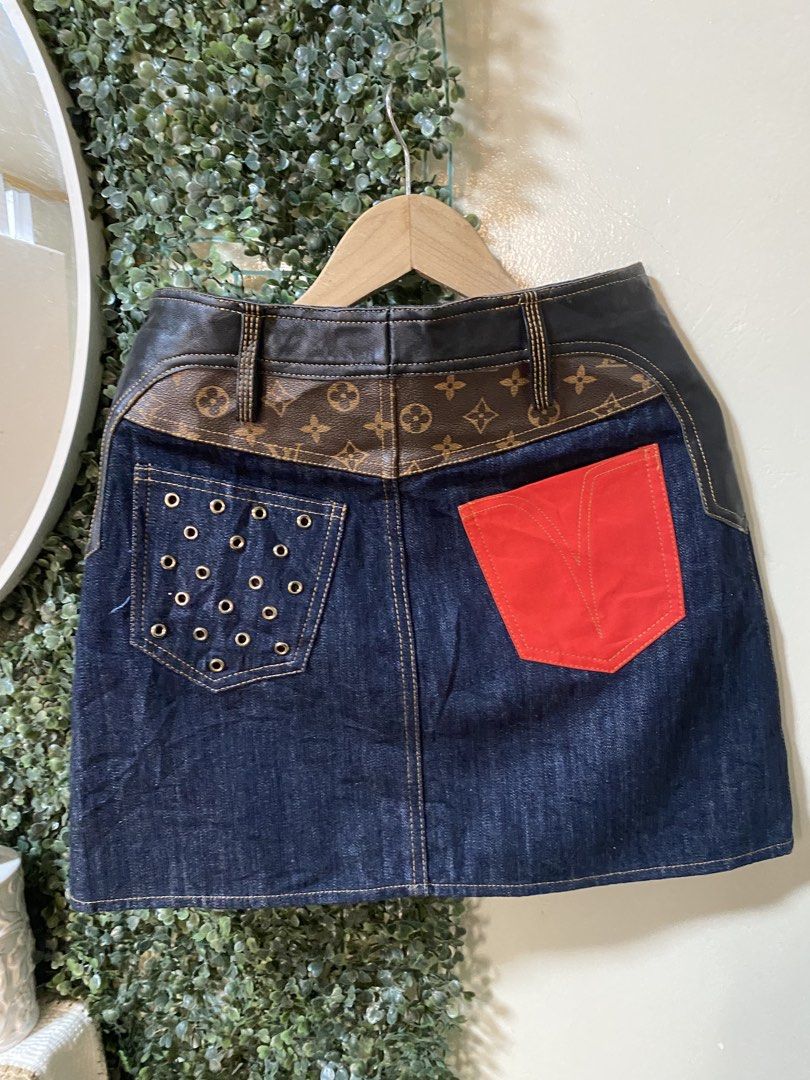 Louis Vuitton Denim Skirt (Category: Luxury Apparel) located in Manila. Submitted by avathriftedcloset (Listing ID 1424599876, Image 3). Description: - Authentic Louis Vuitton denim skirt - Size: S - Dark denim wash - Leather and monogram detailing - Gold button closures - Features pockets - Unique back design with red pocket and metal eyelets.