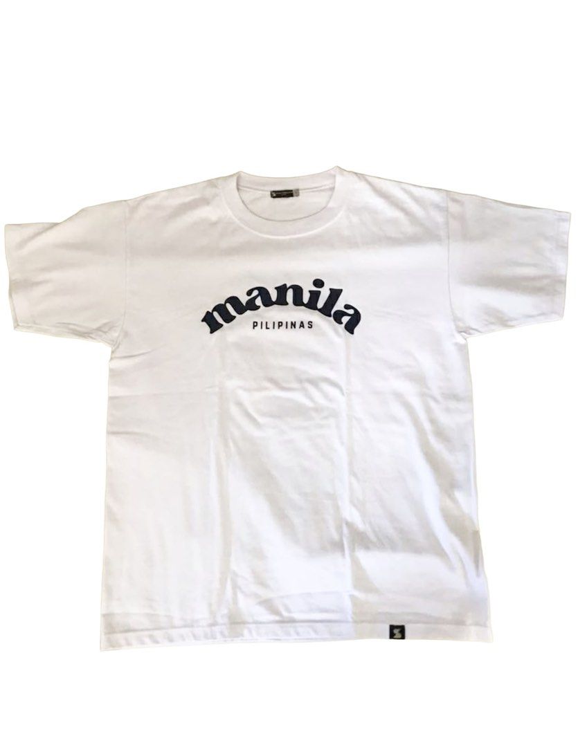 Manila Pilipinas T-shirt (Category: Tshirts & Polo Shirts ) located in Makati City. Submitted by things77 (Listing ID 1424563304, Image 1). Description: - White T-shirt - Features "Manila" arched across the chest with "Pilipinas" below. - Crew neck and short sleeves. - Size: L W: 20 inches H: 26 inches.