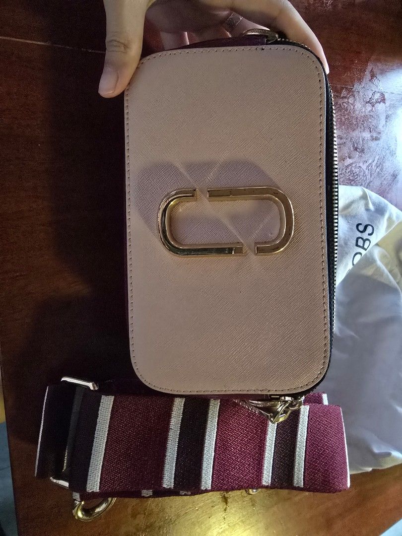 Marc Jacobs The Box Bag (Category: Luxury Bags & Wallets) located in Marikina City. Submitted by any.prelvd (Listing ID 1424531194, Image 3). Description: - Authentic Marc Jacobs The Box Bag - Blush pink leather exterior - Gold-tone logo and zipper - Detachable striped strap - Includes dust bag - Perfect for everyday or special occasions.